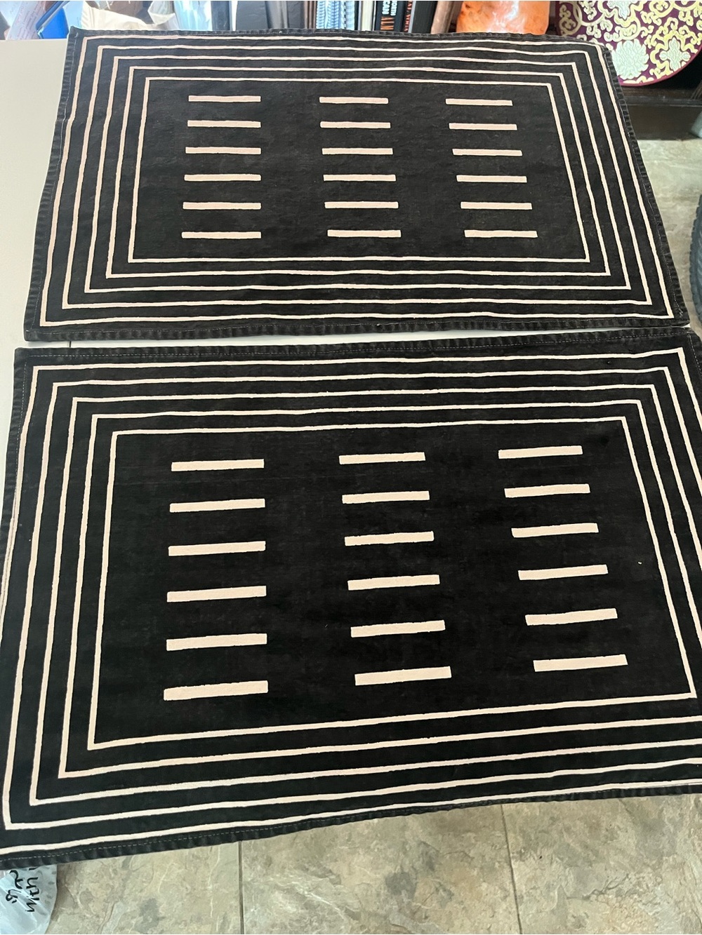 Two black and white striped placemats